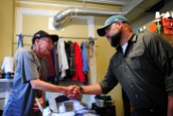 Former Army member Tom Glacken, left, shakes hands with Executive Director José Martinez Sept. 28, 2016 at The Veterans Group in Philadelphia, Pa. The non-profit is committed to promoting the health and well-being of former armed forces service members. Martinez said Glacken is one of the first residents and go way back.