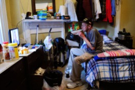 Former Army member Tom Glacken uses a nebulizer while watching television in his room Sept. 28, 2016 at The Veterans Group in Philadelphia, Pa. The non-profit is committed to promoting the health and well-being of former armed forces service members.