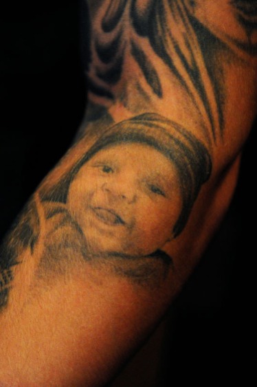 A tattoo of his 3-year-old son, Aidan, is shown on Nick Hughes' arm Sept. 28, 2016 at The Veterans Group in Philadelphia, Pa. The non-profit is committed to promoting the health and well-being of former armed forces service members.