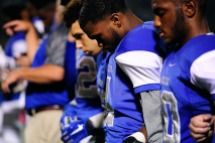 BENSALEM, PA - OCTOBER 21: Bensalem's Mikal Morris #4 pays respects during the national anthem before a Suburban One League National Conference football game against the Council Rock North Indians at Bensalem High School Oct. 21, 2016. Bensalem won 21-20. (Photo by Corey Perrine)